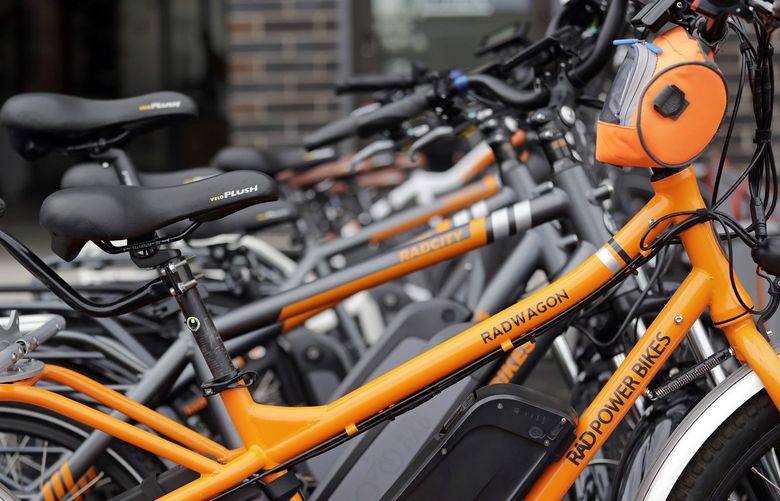 In this photo taken Wednesday, May 15, 2019, electric bicycles are lined-up outside Rad Power Bikes in Seattle, where the bicycle company said that they will absorb 100% of any tariff on their Chinese-made bicycles. From airplanes made by Boeing to apples, cherries and wheat grown by farmers, no other state is more dependent on international trade than Washington. As the tariff disputes escalate, small factories are closing and manufacturing behemoths like Boeing are increasingly worried about access to crucial Asian markets that have helped propel the state’s booming economy.  (AP Photo/Elaine Thompson) WAET202