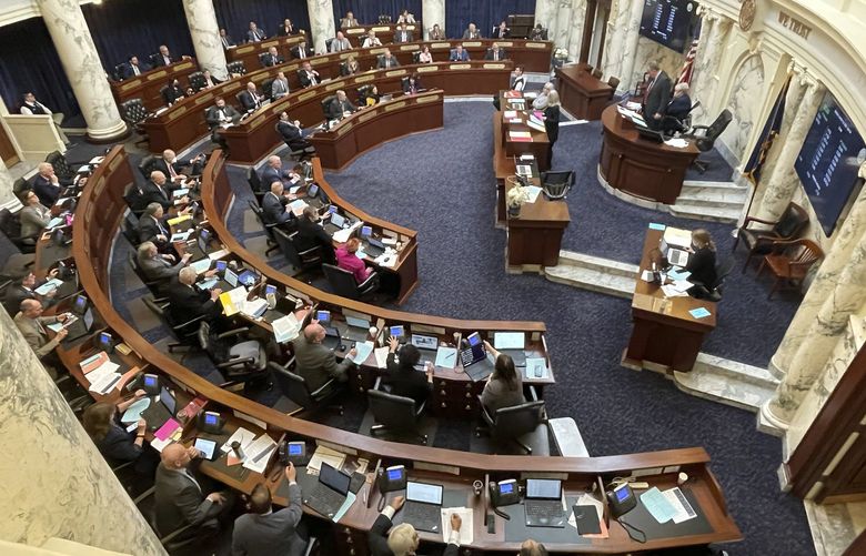 FILE – The Idaho House of Representative is seen in session on March 14, 2022, at the Statehouse in Boise, Idaho. It appears it’s going to take a dozen House Democrats if Idaho is to hang on to more than a billion dollars in federal coronavirus relief money. A majority of the 58 House Republicans often vote against budget bills containing Idaho’s share of the $1.9 trillion American Rescue Plan Act money, opting instead to send it to other states. (AP Photo/Keith Ridler, File) FX204 FX204
