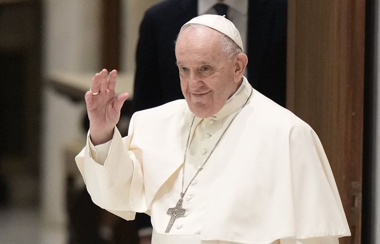Pope Francis waves as he arrives for an audience with members of the members of the Antoniano children choir, at the Vatican, Saturday, March 19, 2022. (AP Photo/Andrew Medichini) AJM103 AJM103