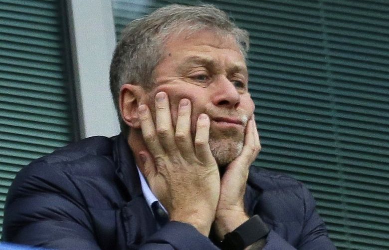 FILE – Chelsea soccer club owner Roman Abramovich sits in his box before their English Premier League soccer match against Sunderland at Stamford Bridge stadium in London, Dec. 19, 2015. The Football Association says Chelsea has withdrawn its request to play its FA Cup game against Middlesbrough without a crowd, a proposal that had sparked fierce opposition from the second-tier club hosting the match. The Premier League team had proposed no fans because the government wonâ€™t allow Chelsea to sell any tickets under the terms of its license to operate after owner Roman Abramovich was sanctioned. (AP Photo/Matt Dunham, File) FP151 FP151