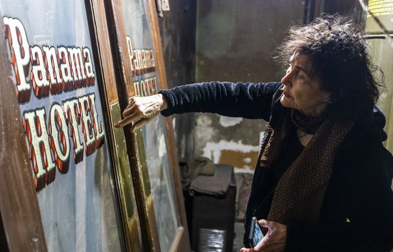 In the basement, owner of the Panama Hotel Jan Johnson, looks at historic doors at the Panama Hotel in Chinatown-International District in Seattle on Wednesday, March 9, 2022. She says that the a part of the hotel will be made into a museum that will house objects left from families from the time of Japanese internment.