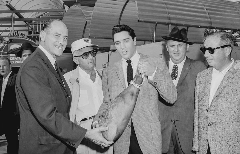 During filming of his film, “It Happened at the World’s Fair.” Elvis Presley presents Gov. Al Rosellini with a ham supposedly from Elvisâ€™ Tennessee ranch. It came from a Seattle supermarket.
Credit: Courtesy Museum of History & Industry
Original MOHAI slug: 1986.5.40806.2