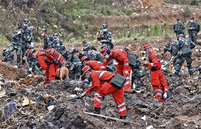 In this photo released by Xinhua News Agency, rescue workers search for the black boxes at a plane crash site in Tengxian county, southwestern China’s Guangxi Zhuang Autonomous Region, Tuesday, March 22, 2022. A China Eastern flight 5735 carrying 123 passengers and nine crew members crashed outside the city of Wuzhou in the Guangxi region while flying from Kunming, the capital of the southwestern province of Yunnan, to Guangzhou, an industrial center not far from Hong Kong on China’s southeastern coast. It ignited a fire big enough to be seen on NASA satellite images before firefighters could extinguished it. (Zhou Hua/Xinhua via AP) XIN804 XIN804