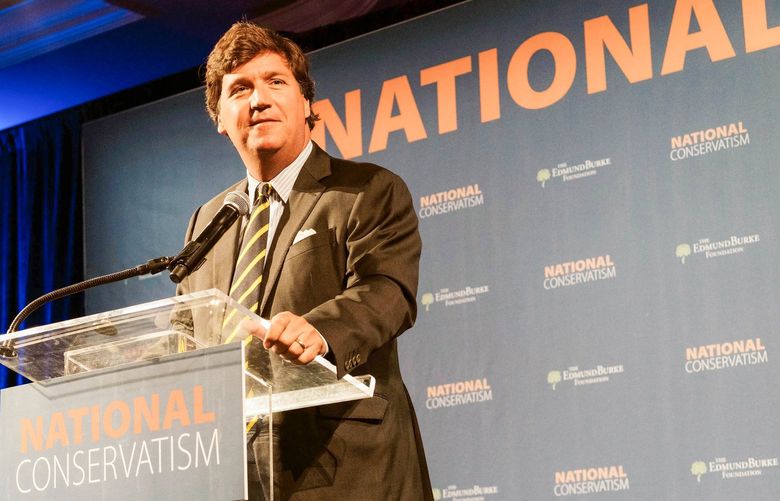 FILE – In this July 15, 2019, file photo, Fox News host Tucker Carlson speaks at the National Conservatism Conference in Washington. Carlson has echoed Russian claims that the invasion of Ukraine was taken in self-defense. He has also criticized Russia’s president, Vladimir Putin.