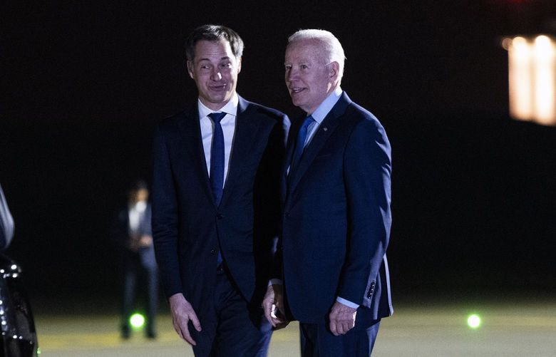 President Joe Biden, right, is greeted by Prime Minister Alexander De Croo of Belgium as he arrive at the airport in Brussels on Wednesday night, March 23, 2022. Biden is expected to announce sanctions on Russian lawmakers before meeting with NATO allies and the European Union on Thursday. (Doug Mills/The New York Times) XNYT206 XNYT206