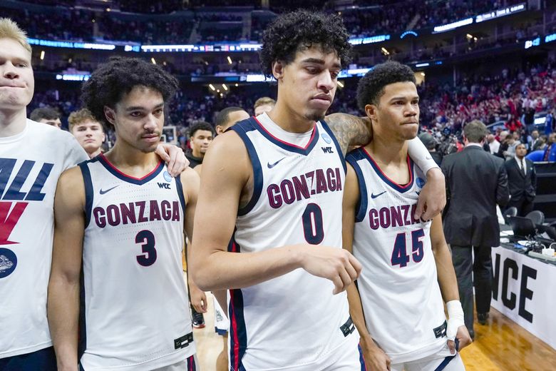 Andrew Nembhard (3) walks off the floor with Julian Strawther (0) and Rasir Bolton (45) after Gonzaga was defeated by Arkansas in the Sweet 16 round of the NCAA tournament in San Francisco. (Marcio Jose Sanchez / AP)