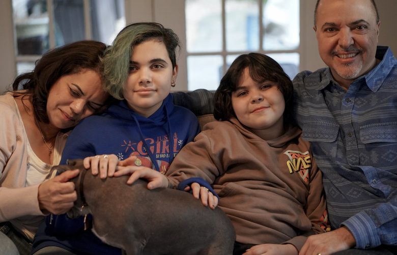 Camille, Alexandra, Leon and Homero Rey at home on March 10, 2022 in Potomac, Md. Leon, 9, is transgender and his family moved from Texas to protect his rights. MUST CREDIT: Washington Post photo by Bonnie Jo Mount