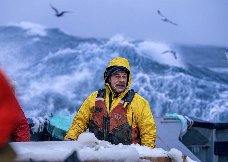 First mate Eben Brown talks with his crew as they break ice from the surfaces of the Pinnacle Jan. 18 southwest of St. Matthew Island. Ice from freezing spray can add a significant amount of weight to a boat, jeopardizing its stability. (Loren Holmes / Anchorage Daily News) 