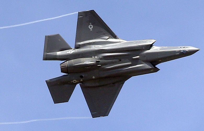 FILE – In this Sept. 2, 2015, file photo, an F-35 jet flies over its new operational base at Hill Air Force Base, in northern Utah. Singapore’s Defense Minister Ng Eng Hen told Parliament on Friday that the government has decided to purchase four F-35 fighter jets made by Lockheed Martin of the United States, with an option for another eight. (AP Photo/Rick Bowmer, File) TKMY102
