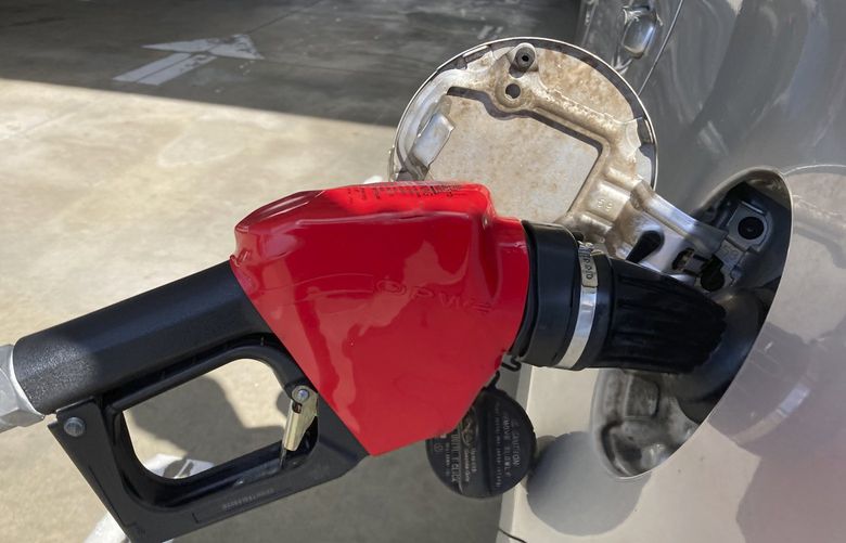 A car is shown at a gas pump, Friday, Jan. 21, 2022, at a gas station in North Miami, Fla. (AP Photo/Wilfredo Lee) FLWL202 FLWL202
