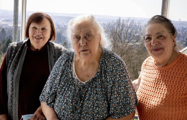 Ukrainian Holocaust survivors Tatyana Zhuravliova, right, Larisa Dzuenko, left, and Galina Ulyanova pose for a photo during an AP interview in an old people’s home in Frankfurt, Germany, Sunday, March 27, 2022.  (AP Photo/Michael Probst) PRO106 PRO106