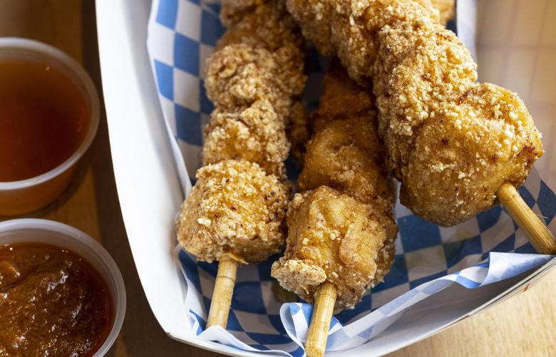Friday, March 25, 2022.   Chicken on a stick with vinegar and banana ketchup from The Chicken Supply restaurant in Seattle’s Greenwood district.   219928
