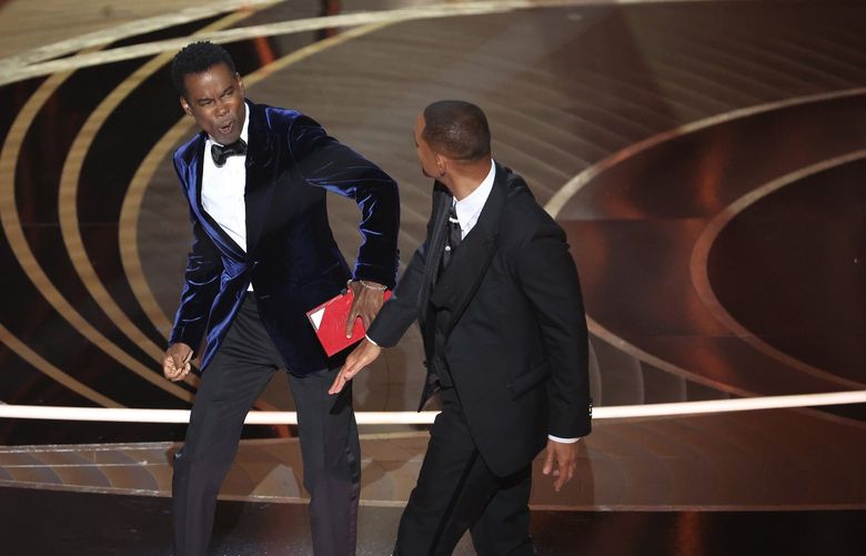 Chris Rock, left, and Will Smith onstage during the 94th Academy Awards at the Dolby Theatre on Sunday, March 27, 2022, in Hollywood, California. (Myung Chun/Los Angeles Times/TNS) 43800889W 43800889W
