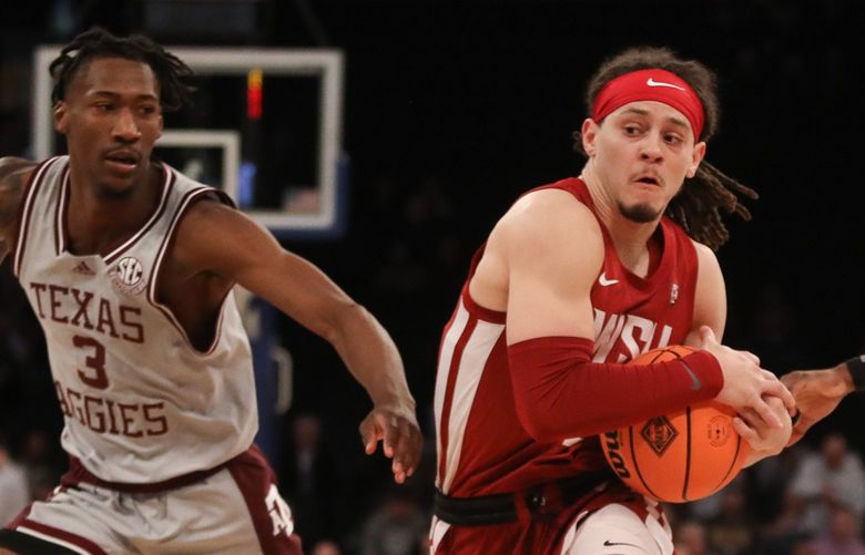 Washington State guard Tyrell Roberts moves the ball past two Texas A&M defenders in the first half of the NIT semifinals, Tuesday, March 29, 2022 at Madison Square Garden in New York. (Ashley Davis / WSU)