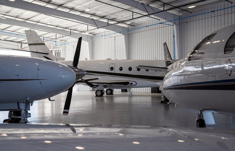 Planes at the 30,000-square-foot hangar of Schubach Aviation, a jet charter operator, at McClellan-Palomar Airport in Carlsbad, Calif., on March 14, 2022. Developers are rapidly expanding hangar space at airports across the country to keep up with a growing demand for places to park private planes. (Ariana Drehsler/The New York Times)