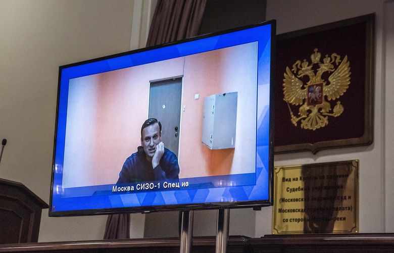 Russian opposition leader Alexei Navalny, shown on a screen while in detention during a court hearing last year in Moscow, Jan. 28, 2021. The Finnish company Nokia played a key role in enabling Russia’s cyberspying, documents show, raising questions of corporate responsibility. (Sergey Ponomarev / The New York Times) 
