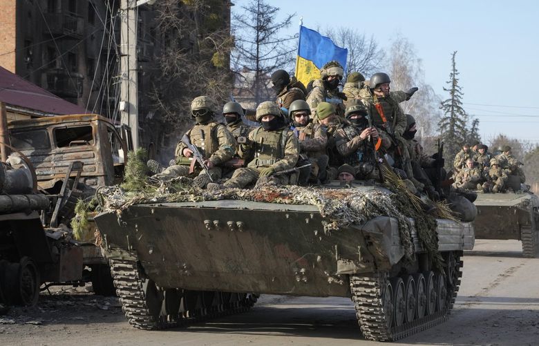Ukrainian soldiers ride on APC through the town of Trostsyanets, some 400 km eastern of capital Kyiv, Ukraine, Monday, March 28, 2022. The more than month-old war has killed thousands and driven more than 10 million Ukrainians from their homes including almost 4 million from their country. (AP Photo/Efrem Lukatsky) XEL111 XEL111