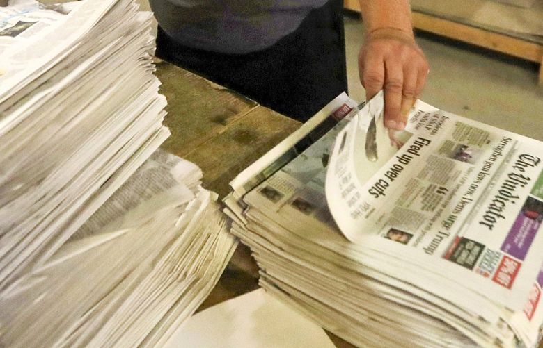 FILE – In this  Aug. 6, 2019, file photo, an employee sorts newspapers for delivery at a distribution center in Liberty Township near Youngstown, Ohio. Pew Research Center data released this week showed that 2020 was the first year that the newspaper industry earned more money from circulation than advertising.