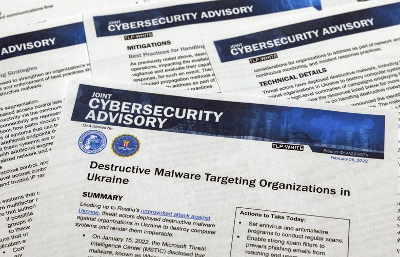 A Joint Cybersecurity Advisory published by the Cybersecurity & Infrastructure Security Agency about destructive malware that is targeting organizations in Ukraine is photographed Monday, Feb. 28, 2022. (AP Photo/Jon Elswick) MDJE401