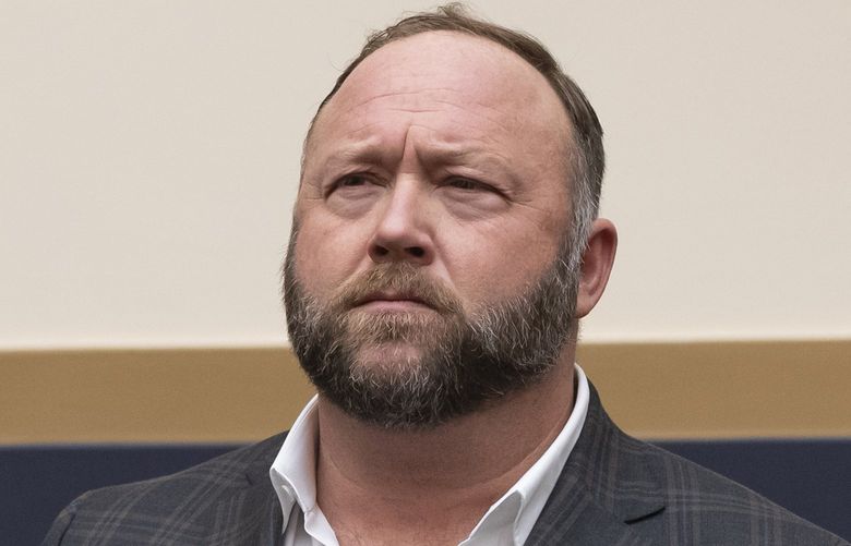 FILE – This Tuesday, Dec. 11, 2018, file photo shows radio show host and conspiracy theorist Alex Jones at Capitol Hill in Washington. Infowars host Jones has offered to pay $120,000 per plaintiff to resolve a lawsuit by relatives of Sandy Hook Elementary School shooting victims who said he defamed them by asserting the massacre never happened, according to court filings Tuesday, March 29, 2022. (AP Photo/J. Scott Applewhite, File) NYSB226 NYSB226