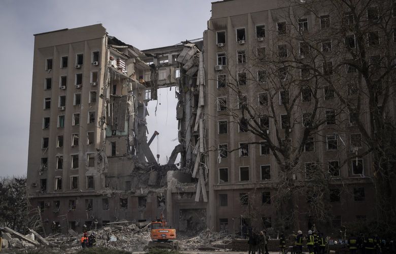 Emergency personnel work at the site of the regional government headquarters of Mykolaiv, Ukraine, following a deadly Russian attack, on Tuesday, March 29, 2022. (AP Photo/Petros Giannakouris) NYAG502 NYAG502