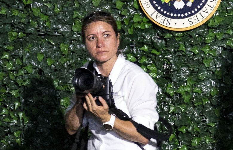 FILE – Shealah Craighead, then the official White House photographer, looks on as then-President Donald Trump takes the stage to speak at an event in Williamsburg, Va., on July 30, 2019. Craighead made plans to publish a book of Trump photos, but the former president had other plans. (Doug Mills/The New York Times)
