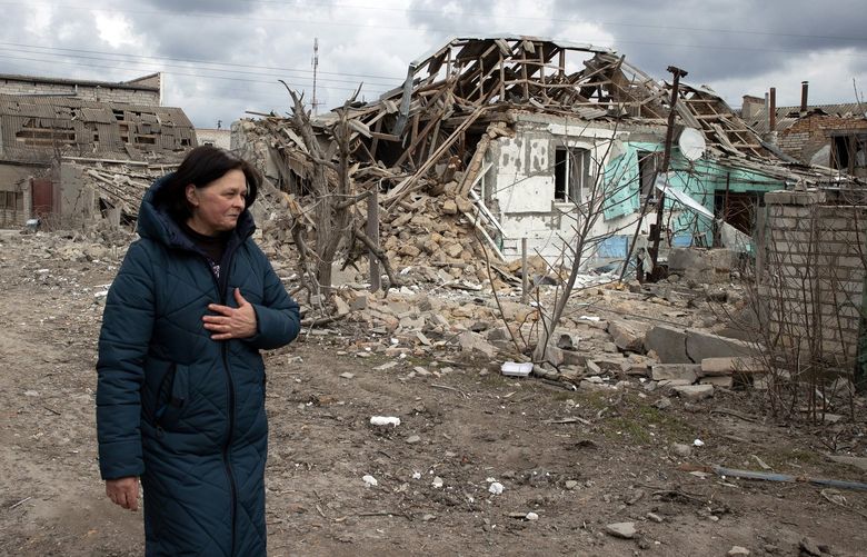 FILE – A woman weeps as she surveys the damage to a residential street in the village of Ternovka, near Mykolaiv, Ukraine, that was attacked by Russian forces the day before, March 8, 2022. In the weeks since Russia began its invasion, more than 953 civilians have been killed, including at least 78 children, according to the United Nations high commissioner for human rights, who noted that the real toll was likely to be considerably higher. (Tyler Hicks/The New York Times)