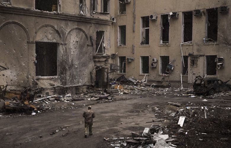 A Ukrainian serviceman walks outside the regional administration building, heavily damaged after a Russian attack earlier this month in Kharkiv, Ukraine, Sunday, March 27, 2022. (AP Photo/Felipe Dana) XFD101 XFD101