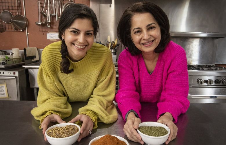 Sadaf Ahmed, left, and her mom Kausar Ahmed, Thursday, March 10, 2022 in Kent, are the owners and chefs at Karachi Kitchen, a company that specializes in traditional Pakistani spice blends and chutneys that they create and market themselves. 219773