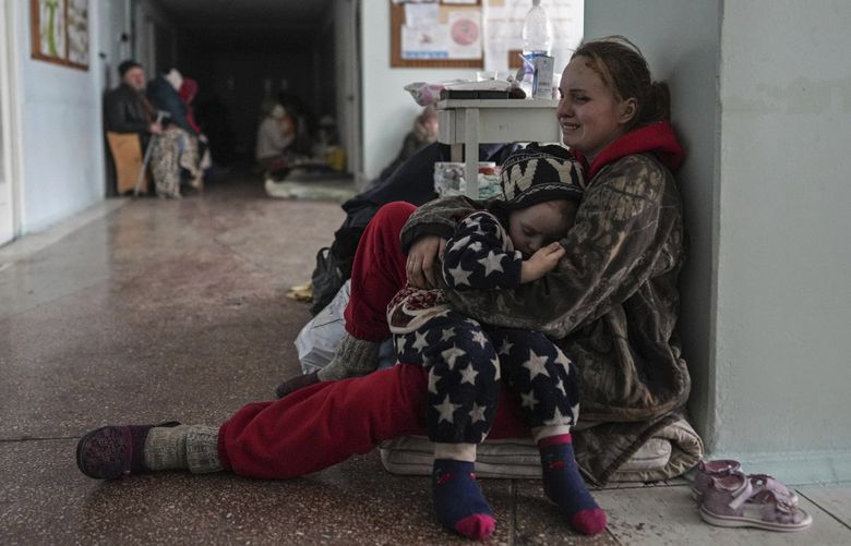Anastasia Erashova cries as she hugs her child in a corridor of a hospital in Mariupol, Ukraine on Friday, March 11, 2022. Anastasia’s other child was killed during shelling in Mariupol. (AP Photo/Evgeniy Maloletka) NYAG929 NYAG929