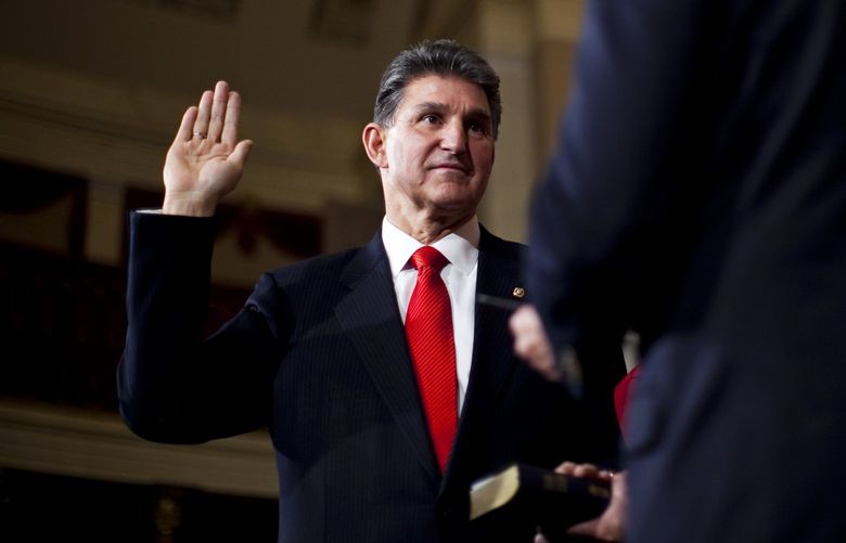 FILE – Sen. Joe Manchin (D-W.Va.) takes the oath from Vice President Joe Biden during his ceremonial swearing in at the Capitol in Washington, Nov. 15, 2010. (Drew Angerer/ The New York Times) XNYT60 XNYT60