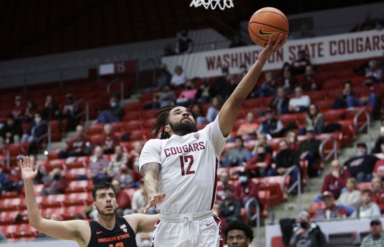 Washington State guard Michael Flowers shoots in front of Oregon State center Roman Silva, left, and guard Dexter Akanno during the second half of an NCAA college basketball game Thursday, March 3, 2022, in Pullman, Wash. Washington State won 71-67. (AP Photo/Young Kwak) WAYK111 WAYK111