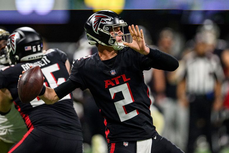 First look: Atlanta Falcons newly signed quarterback Marcus Mariota holding  his Falcons jersey, speaking with media