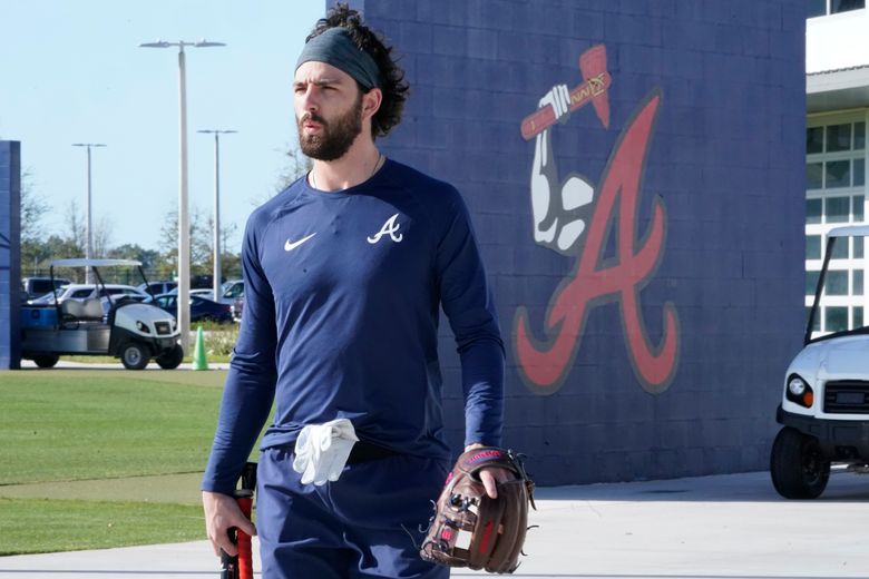 Atlanta Braves shortstop Dansby Swanson walks in the dugout during
