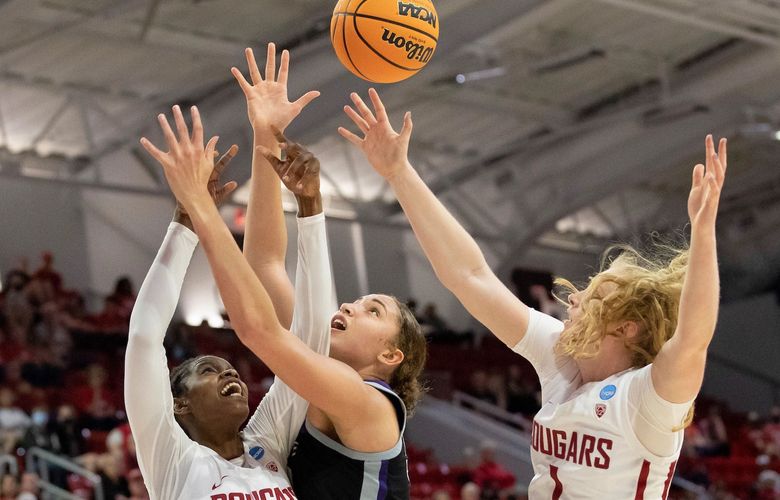 Washington State’s Bella Murekatete (55) and Tara Wallack (1) battle for a rebound with Kansas State’s Ayoka Lee, middle, during the first half of a college basketball game in the first round of the NCAA tournament in Raleigh, N.C., Saturday, March 19, 2022. (AP Photo/Ben McKeown)