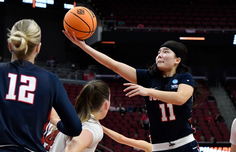 Gonzaga guard Kayleigh Truong (11) goes in for a layup past the Nebraska defense during the first half of their women’s NCAA Tournament college basketball first round game in Louisville, Ky., Friday, March 18, 2022. (AP Photo/Timothy D. Easley)