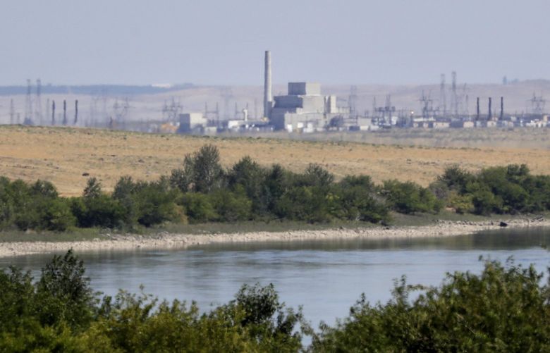 In this Wednesday, Aug. 14, 2019 photo, buildings on the Hanford Nuclear Reservation along the Columbia River are seen from the Hanford Reach National Monument near Richland, Wash. A handful of sites where the United States manufactured and tested some of the most lethal weapons known to humankind are now peaceful havens for wildlife, where animals and habitats flourished on obsolete nuclear or chemical weapons complexes because the sites banned the public and most other intrusions for decades.
