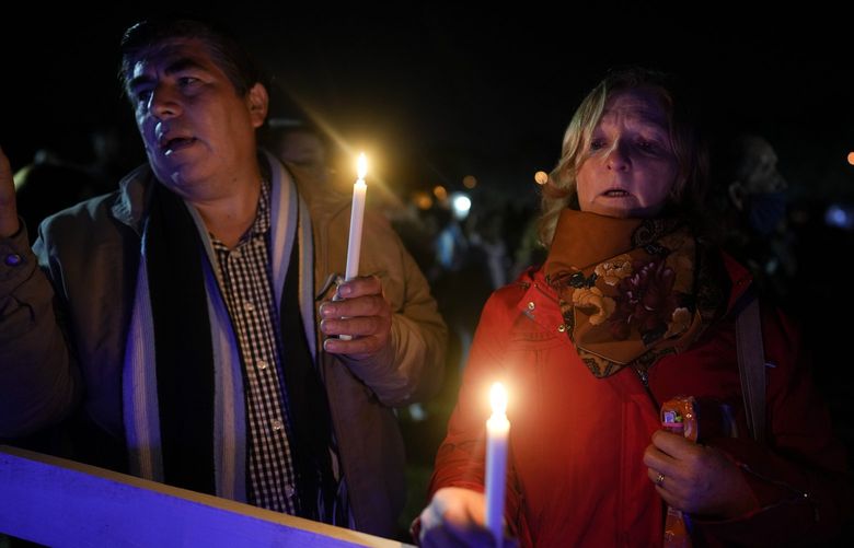 People sing the national anthem at a memorial during an event marking the 40th anniversary of the conflict between Argentina and Great Britain over the remote South Atlantic archipelago in Pilar, Argentina, Saturday, April 2, 2022. (AP Photo/Natacha Pisarenko) XNP117 XNP117