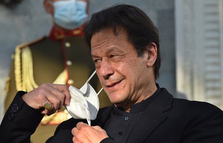 Pakistan’s Prime Minister Imran Khan removes his face mask during a joint news conference at the Presidential Palace in Kabul, Afghanistan, on Nov. 19, 2020. (Wakil Kohsar/AFP via Getty Images/TNS) 44246671W 44246671W
