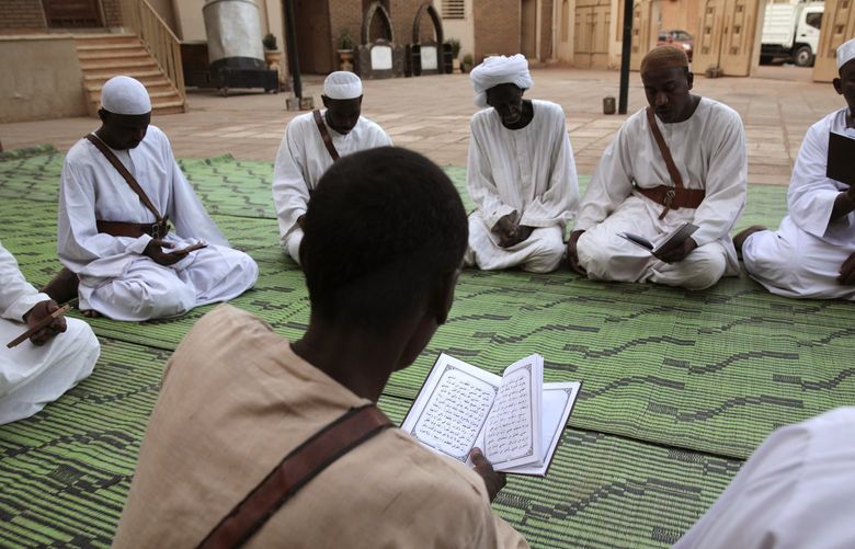 Sudanese men read the Quran during the holy month of Ramadan at the Sheikh greeb Allah Mosque in Oumdrman, Khartoum, Sudan, Saturday, April 2, 2022. (AP Photo/Marwan Ali) MA101 MA101