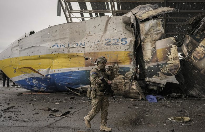 A Ukrainian serviceman walks by the front section of an Antonov An-225 Mriya aircraft destroyed during fighting between Russian and Ukrainian forces at the Antonov airport in Hostomel, Ukraine, Saturday, April 2, 2022. At the entrance to Antonov Airport troops manned their positions, a sign they are in full control of the runway that Russia tried to storm in the first days of the war.(AP Photo/Vadim Ghirda) XVG124 XVG124