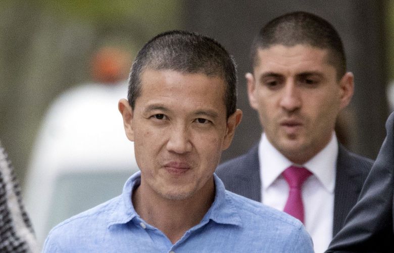 FILE – Former Goldman Sachs executive Roger Ng, left, leaves Brooklyn Federal court with attorney Marc Agnifilo, right, May 6, 2019, in New York. A jury began deliberations on Tuesday, April 5, 2022, at a U.S. trial stemming from an audacious scheme involving former Goldman Sachs bankers to ransack a Malaysian state investment fund known as 1MBD. (AP Photo/Mary Altaffer, File) 