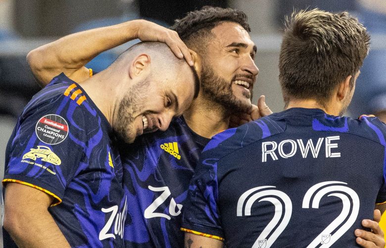 ­Cristian Roldan and Kelyn Rowe celebrate with Jordan Morris after Morris scored in the 35th minute Wednesday.

The New York City Football Club played the Seattle Sounders FC in the first leg of the CONCACAF semifinals Wednesday, April 6, 2022, at Lumen Field, in Seattle, WA. 220040