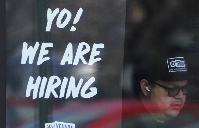 A hiring sign is displayed at a restaurant in Schaumburg, Ill., Friday, April 1, 2022.  (AP Photo/Nam Y. Huh) 