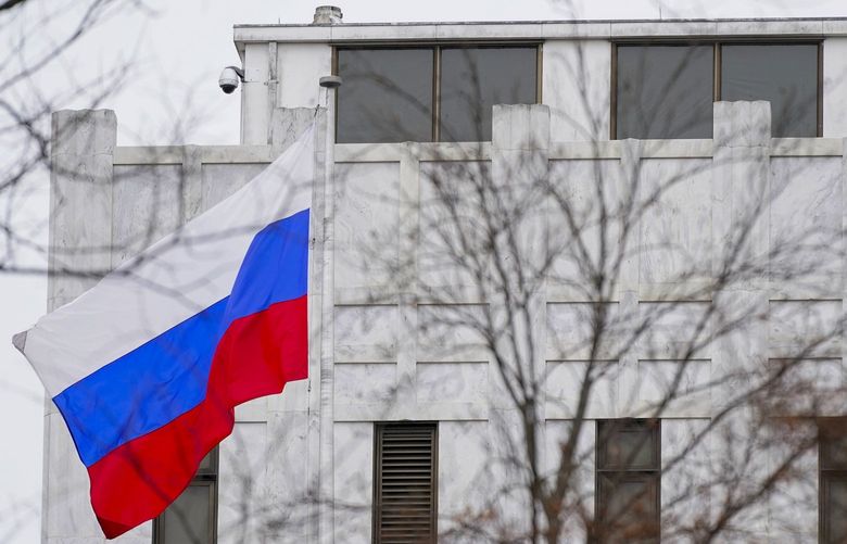 FILE – The Russian flag flies outside the Embassy of Russia in Washington, Feb. 24, 2022. The United States and allies are stepping up sanctions against Russia over its invasion of Ukraine.  (AP Photo/Patrick Semansky, File) ALI101