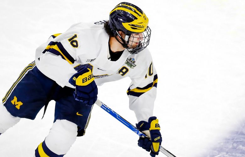 Michigan’s Matty Beniers plays against Denver during the first period of an NCAA men’s Frozen Four semifinal hockey game, Thursday, April 7, 2022, in Boston. (AP Photo/Michael Dwyer) NYOTK
