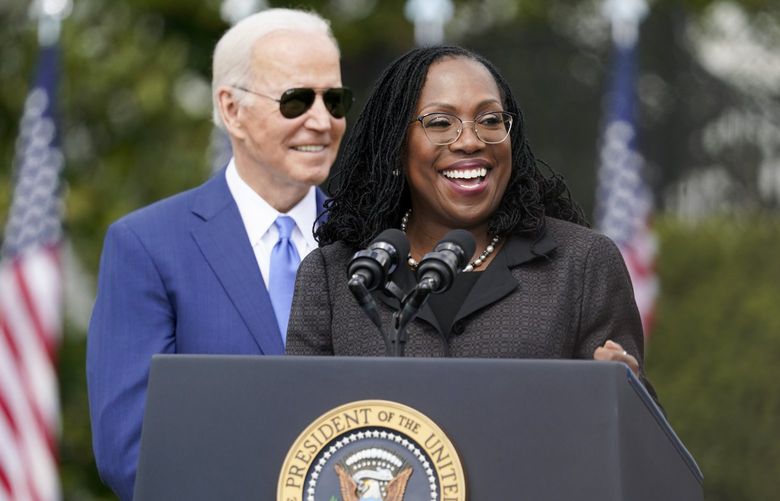 President Joe Biden listens as Judge Ketanji Brown Jackson speaks during an event on the South Lawn of the White House in Washington, Friday, April 8, 2022, celebrating the confirmation of Jackson as the first Black woman to reach the Supreme Court. (AP Photo/Andrew Harnik) DCAH451 DCAH451