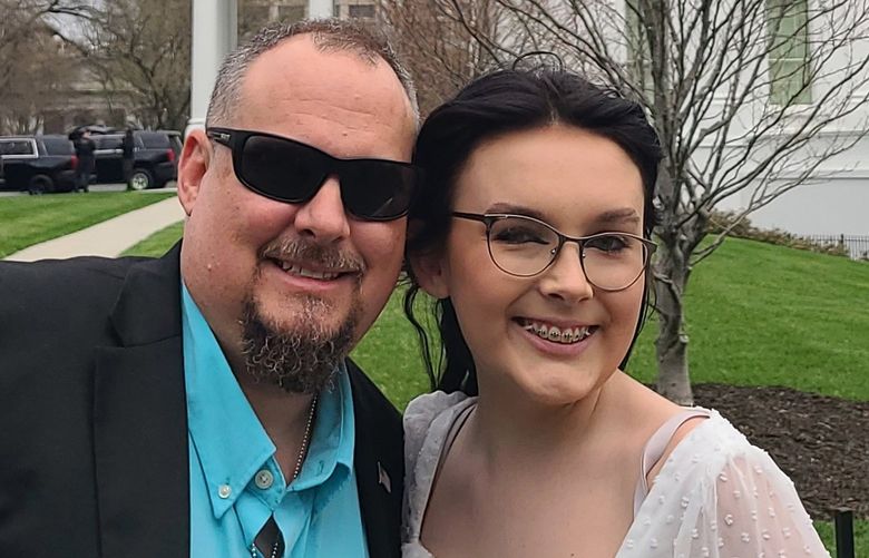 In a photo provided by Jeff Walker, he and his daughter Harleigh of Auburn, Ala., stand outside the White House on March 31, 2022, where they were guests for Transgender Day of Visibility. The family is fighting legislation in Alabama that would outlaw puberty blockers and hormone treatments for trans youth under 19. (Courtesy of Jeff Walker via AP) NY850 NY850