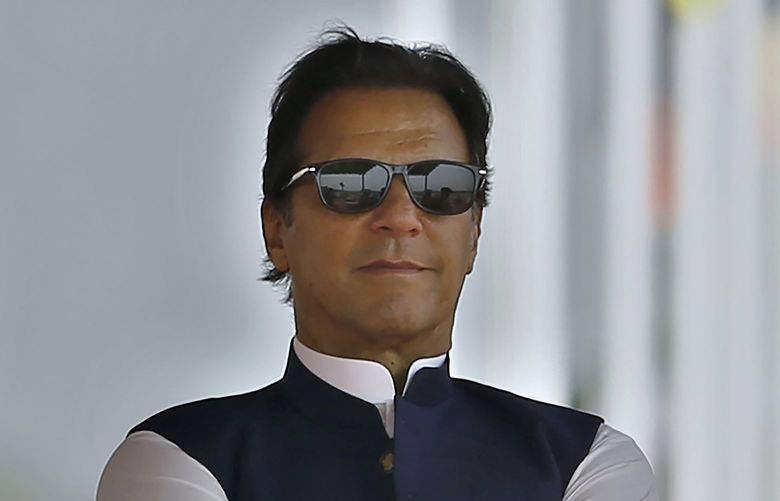FILE – Pakistan’s Prime Minister Imran Khan attends a military parade to mark Pakistan National Day, in Islamabad, Pakistan on March 23, 2022. Pakistanâ€™s embattled prime minister faces a tough no-confidence vote Saturday, April 9, 2022, waged by his political opposition, which says it has the numbers to defeat him. (AP Photo/Anjum Naveed, File) TKMY101 TKMY101