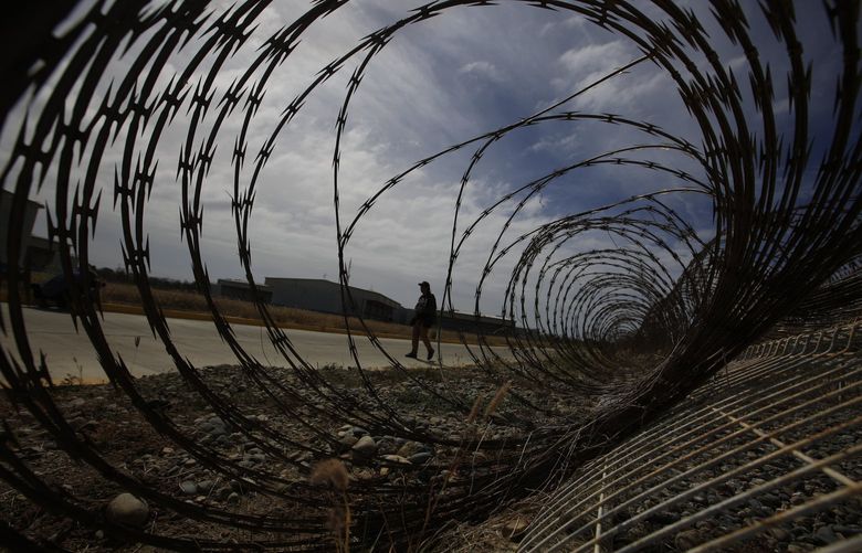 FILE – A journalist walks past a fallen section of fencing during a media tour of the now closed Laguna del Toro maximum security facility on the former Islas Marias penal colony located off Mexico’s Pacific coast, Saturday, March 16, 2019. President AndrÃ©s Manuel LÃ³pez Obrador had the facility converted into an environmental education center. Now the government wants to make it an ecotourism destination where visitors can watch sea birds and enjoy the beaches. (AP Photo/Rebecca Blackwell, File) NY116 NY116